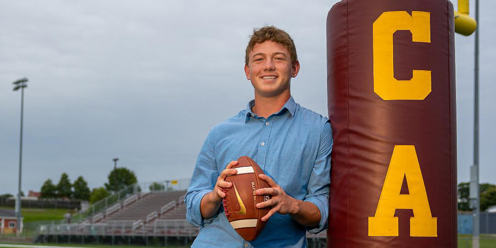 Caden McDuffie posing on Cape Elizabeth's football field