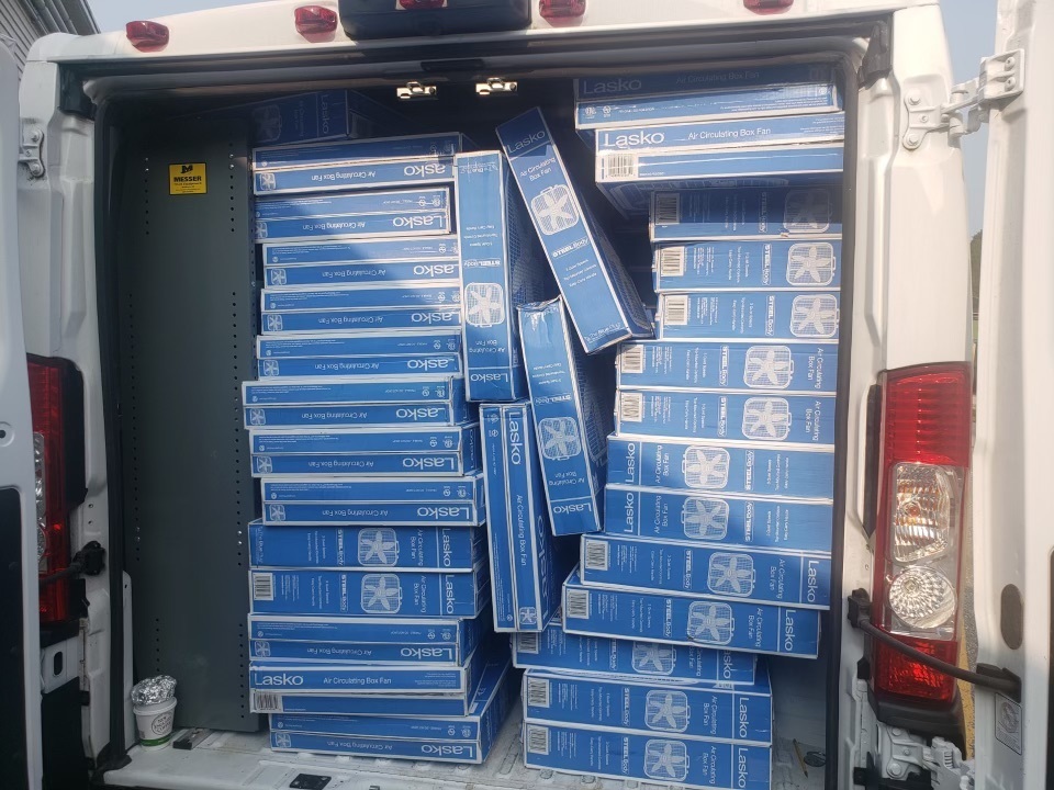 Box Fans stacked in a truck to unload